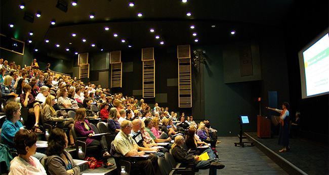A large conference room filled with people
