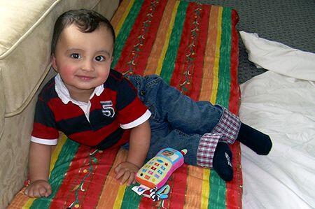 Toddler smiling on a couch