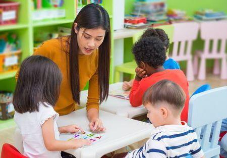 A teacher in a classroom with young children