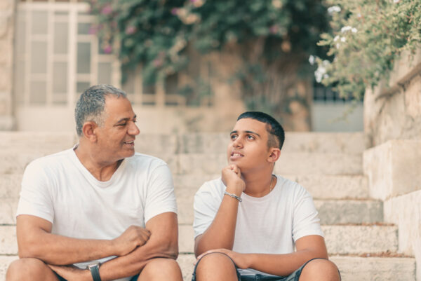 Father with son on stairs chatting