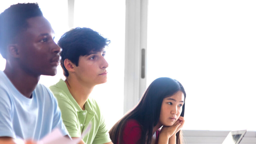 Teenagers in a classroom listening attentively